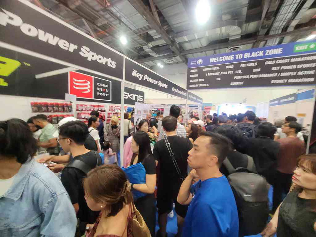 Crowded race stalls and booths hawking various goods and services.